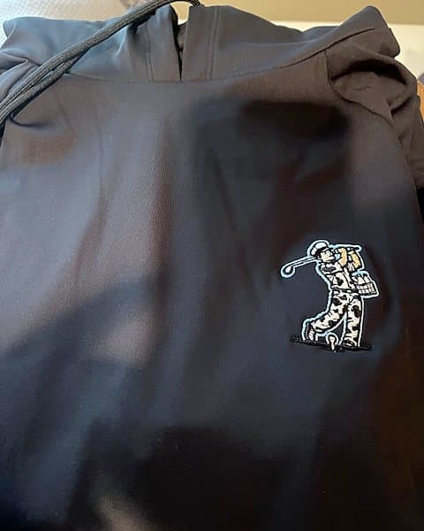 A navy Pichón hoodie with an embroidered milkman golfer