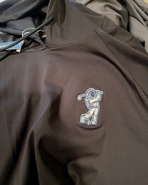 A navy Pichón hoodie with an embroidered astronaut golfer